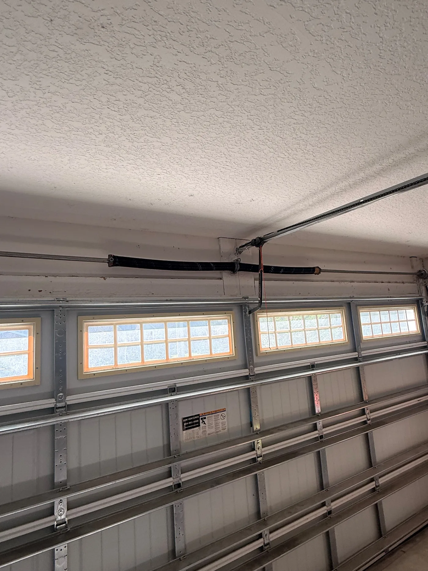 New garage door torsion spring installed after replacement